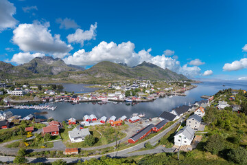 Village image of Sorvagen in middle of lush landscape, with view of Vestfjord in background. Lofoten district in Norway