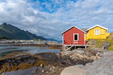 Traditional fishermen's houses, called rorbuer, on rocky coast of Vestfjord. Sorvagen in Lofoten district of Norway