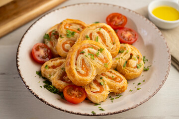 Puff pastry filled with salmon and cheese. Top view table with  decoration.