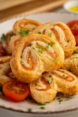 Puff pastry filled with salmon and cheese. Top view table with  decoration.