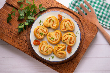 Puff pastry filled with salmon and cheese. Top view table with  decoration.