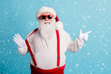 Portrait of his he nice attractive cheerful overweight white-haired Santa demonstrating discount...