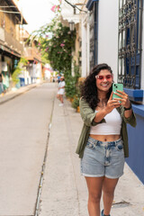 Woman Taking a Selfie on a Vibrant City Street