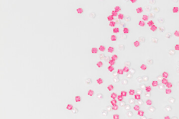 Glowing acrylic beads scattered on a blue background with place for text.