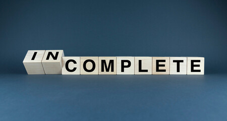 Words INCOMPLETE and COMPLETE on wooden blocks