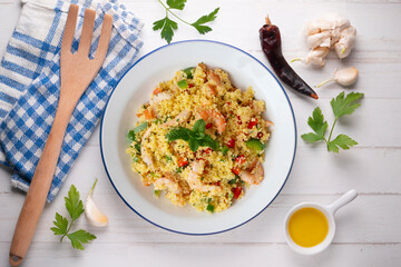 Couscous salad with vegetables and prawns. Top view table with  decoration.