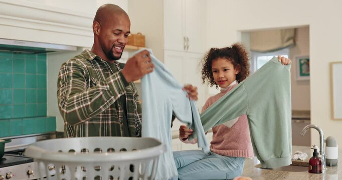 Dad, child and folding clothes in home for house work, learning chores and bonding together. Father, young daughter and helping with laundry in kitchen for cleaning, development and weekend routine