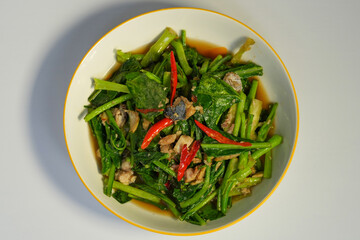 The vegetable is cut into pieces and stir-fried with small pieces of salted mackerel. In Thailand, it is called 