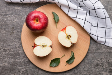 Fresh red apples with green leaves on table. cutting board with knife. Top view