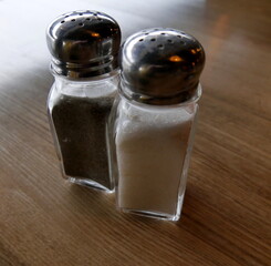 Salt and pepper shakers on table, table seasonings in restaurant