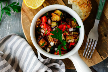 Spicy Grilled Eggplant Salad in a  bowl .top veiw