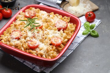 Delicious al forno pasta in baking dish on grey table, closeup