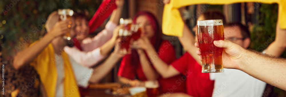 Wall mural Banner. Fans raise their drinks in unison, toasting victory. Blurred background shows more joining celebration, creating lively atmosphere. Concept of Oktoberfest, brewery, vacation, Friday mood.