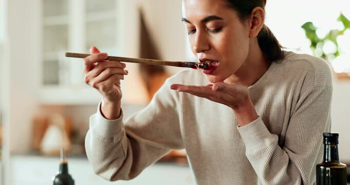 Woman, taste and cooking in house for breakfast, dinner and health with nutrition, flavor and diet. Female person, spoon and happy in kitchen for healthy brunch, meal prep and eating food with test