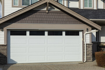 Garage Door. Modern house with garage door. Family house with wide garage door and concrete...