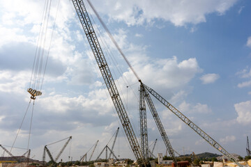 Cranes operate in a marble quarry in Vila Viçosa, Alentejo, showcasing the extraction process of valuable marble, surrounded by stunning natural landscapes.