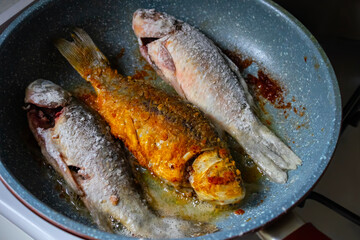 Frying fish in a frying pan. Tasty homemade roasted crucian carp 