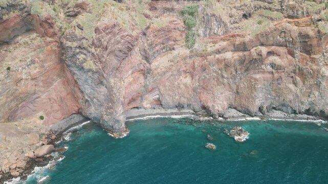 Rocky coastline of the Portuguese island of Madeira near Christo Rei, Canico. Drone aerial video.