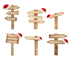 Collection of wooden direction signs with Santa hat isolated on white background