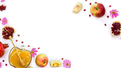 Honey in glass bowl, red apples, garnets, wooden honey dipper, pink flowers on a white background with space for text. Top view, flat lay