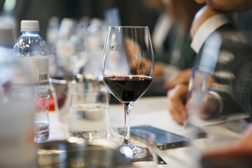 Close-up Photo of Poured Wine Glass on Table During Professional Tasting for Sommeliers