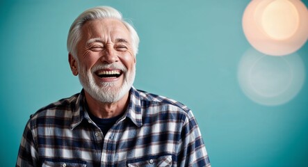 Obraz premium Laughing elderly Caucasian man with white beard wearing flannel shirt on plain turquoise background