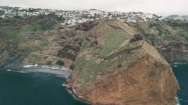 Peninsula with Christo Rei (Christ's Monument) on the Madeira Island near Canico, Portugal. Aerial drone video.