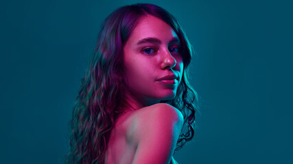 Side profile shot emphasizing smooth, youthful skin under neon lighting, perfect for promoting...