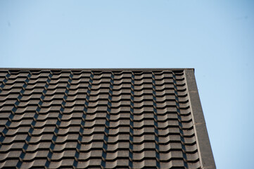 roof with black tile. modern roof tiles of metal. modern building in the city