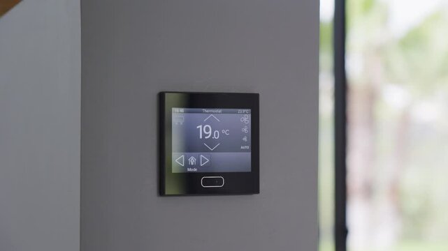 Slow orbiting shot of a temperature control panel changing degrees