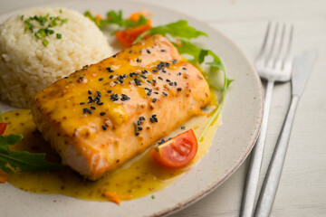 Baked salmon with orange sauce. Top view table with decoration.