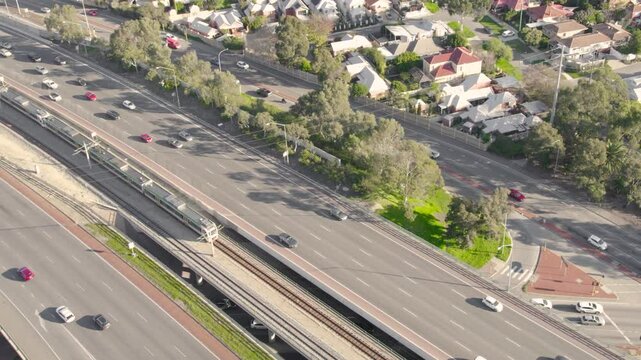 Vehicles and Trains Traveling Along the Australian Highway - Zoom Out Shot