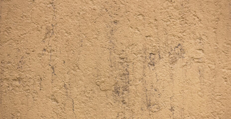 Golden decorative plaster covers uneven walls during apartment renovation. Repair and decoration of premises. Background texture pattern