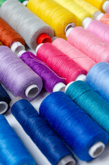 Top view of many colorful thread spools background
