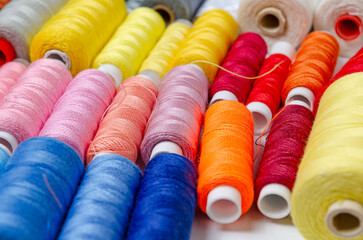 Top view of many colorful thread spools background