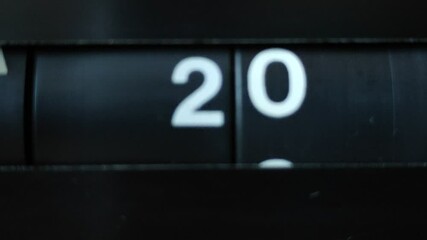 A flip clock flips quickly through the days of the month from 01 to 31. Passing of time concept.