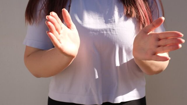 portrait of a young fat woman clapping her hands close-up