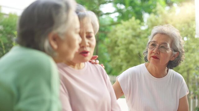 4K Elderly people mental health care concept. Group of Asian senior woman encourage and support each other during talking about mental health life problem thoughtful with psychiatrist in the garden.