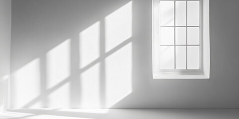 Light streaming through a window onto a white wall, casting geometric shadows in a serene and minimalist interior..