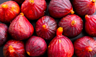 Figs close-up. Heap of figs, whole fruits and cut in half. Sweet exotic fruit for dessert, healthy food.