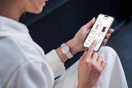 Online Shopping Experience: Woman Browsing Fashion App on Smartphone 