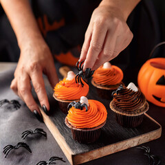 A woman decorates cupcakes with spiders. AI generated.