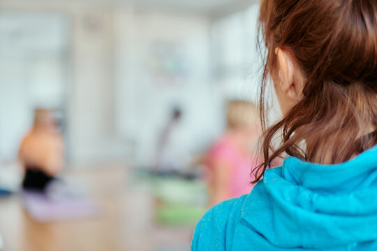 A blurred image of a group of senior women practicing yoga to maintain a healthy and active aging process.