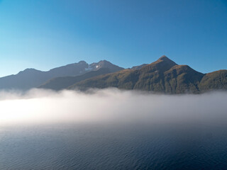 Layer of mist and mountains in Hjorundfjord, Norway