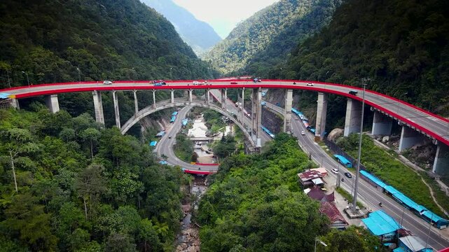 Kelok 9 or Kelok Sembilan is a winding road segment,9 sharp turns from drone, among the high hills with green and dense trees