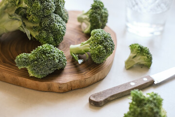 Close up of fresh broccoli on wooden cutting board