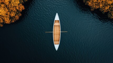 A single white rowboat floats peacefully in blue water, captured from an aerial angle. The setting...