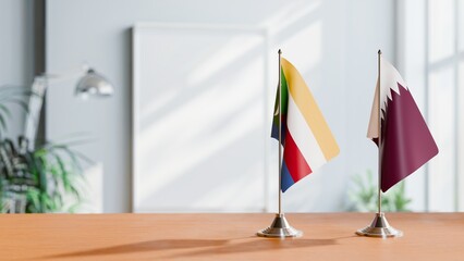 FLAGS OF COMOROS AND QATAR ON TABLE