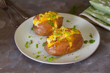 Cheesy stuffed baked potatoes topped with cheese, bacon and cream.