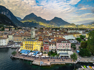 Picturesque town of Riva del Garda by Lake Garda, surrounded by mountains and crystal-clear water.